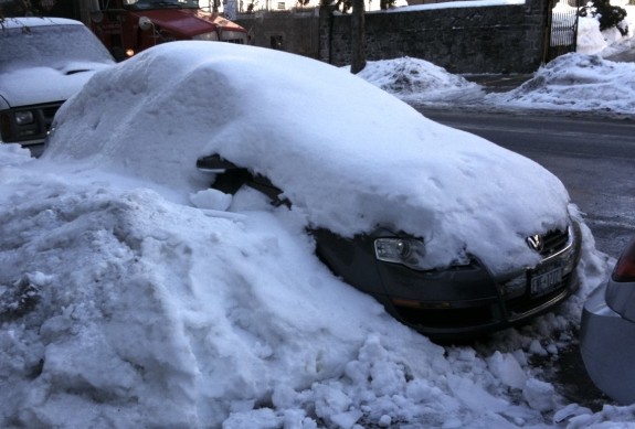 Snow covers car in Upper Manhattan